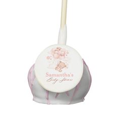 a pink and white baby shower brush with a teddy bear on it