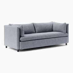 a gray couch sitting on top of a white floor