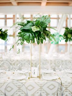 there is a tall vase with flowers on the top of it at this wedding reception