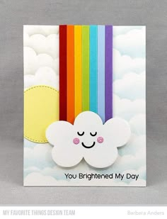 a card with a rainbow and cloud on it