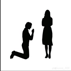 a woman kneeling down next to a man who is looking at his cell phone in silhouette