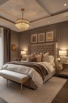 a bedroom with a large bed and chandelier