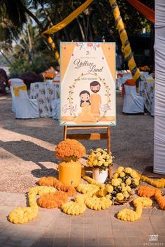 an outdoor ceremony with flowers and decorations on the ground next to a sign that says celebration