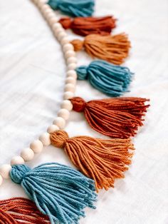 a tasseled necklace with beads and wooden beads