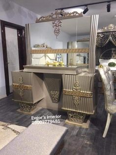 a large mirror sitting on top of a wooden floor next to a table and chair