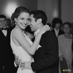 a bride and groom hugging at their wedding reception