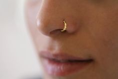 a close up of a person with a nose piercing