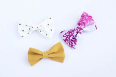 three bow ties laid out on a white surface