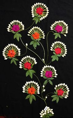 a black background with white, red and yellow flowers in the center on top of it