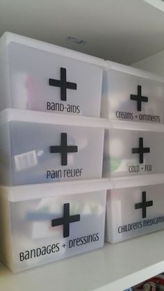 four plastic containers with black crosses on them are sitting on a shelf in a closet