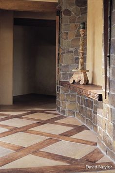 an empty room with stone walls and flooring