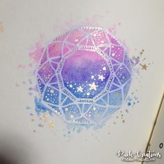 a drawing with watercolor and glitters on it that looks like an ornament