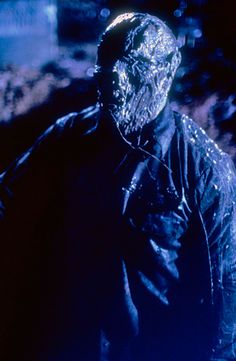 a man standing in the dark with something on his face