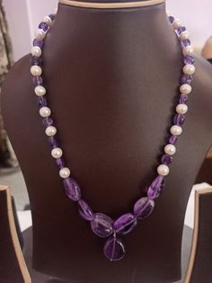 Amethyst Necklace Smooth AAA Tumble Beads With Center Tumble Gemstone 20 inch Necklace Stone : Natural Amethyst Fresh Water Pearl Shape :- Tumble Size :- 7x7-14x18mm 1. Weight :- 237 carat With Amethyst Tumble, 20 INCH Necklace Polish :- Handmade Purity :- 100% Natural Gemstone color - white blue It is known as the 'love stone' as the message it emits is the strong vibration of unconditional love, joy, warmth and healing. As quartz crystals are profound amplifiers of energy, it may help to kindl Amethyst Gemstone Necklaces With Round Beads, Healing Amethyst Necklaces With Polished Beads, Healing Amethyst Necklace With Polished Beads, Purple Beaded Necklaces With Stones For Gifts, Purple Amethyst Pearl Necklace, Purple Rondelle Gemstone Bead Necklaces, Purple Amethyst Gemstone Beads Pearl Necklace, Purple Amethyst Pearl Necklace With Gemstone Beads, Purple Necklace With Round Stone Beads