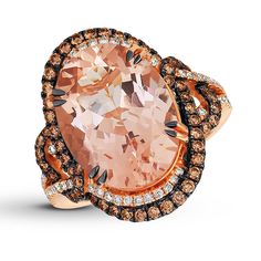 An oval Peach Morganite™ surrounded by swirls of rich Chocolate Diamonds® with black rhodium prongs and elegant Vanilla Diamonds® form the center of this exquisite ring from Le Vian®. Additional Chocolate Diamonds® line the 18K Strawberry Gold® band, bringing the total diamond weight to 7/8 carat. Le Vian®. Discover the Legend. Please note: This ring is available in limited sizes. If you don't see your size here, please visit a store to order your ring. Gold Stock, Peach Morganite, Jewelry Education, Jewelry Advice, Chocolate Diamonds, Le Vian, Diamond Guide, Morganite Ring, Brown Diamond