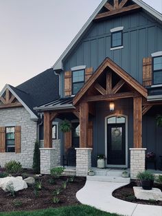 a house that has some plants in the front yard and grass on the ground around it