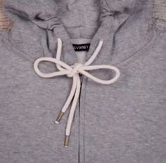 a gray hoodie with a white tie on it