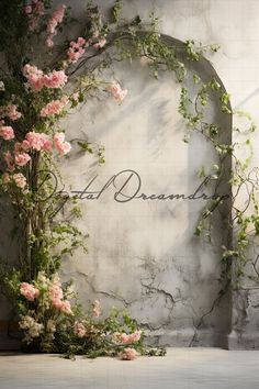 an arch with pink flowers and vines on it in front of a stone wall that says dead dreaming