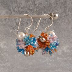 Lovely ball earrings with color power. Seed beads from Japan, freshwater pearls, a lot of different beads. Earrings are 4 cm long and the ball is 2,2 cm. Silver or gold plated hooks.  FAST SHIPPING   Need this item fast? We offer a Faster Shipping option here: https://www.etsy.com/shop/smykkeunivers/?etsrc=sdt&section_id=41039562 Europe 2-4 business days USA, Canada and rest of the world 4-7 business days Any questions, just ask. Handmade Fusion Style Bridal Drop Earrings, Handmade Multicolor Drop Bridal Earrings, Multicolor Handmade Drop Bridal Earrings, Multicolor Beaded Earrings For Wedding, Handmade Dangle Cluster Earrings For Anniversary, Unique Beaded Wedding Earrings, Handmade Multicolor Earrings For Anniversary, Multicolor Crystal Earrings For Wedding, Anniversary Beaded Dangle Earrings