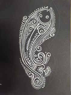 an intricately designed black paper with white ink