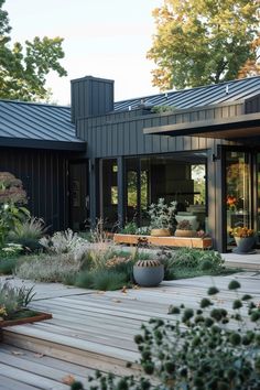 a wooden deck surrounded by lots of plants and potted plants on top of it