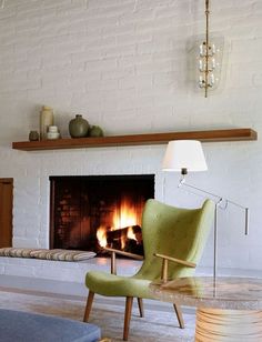 a living room with a fireplace and chairs