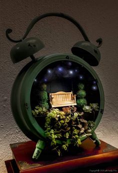 a green clock with a bench in the middle of it and plants growing out of it