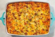 a casserole dish with meat and cheese in it sitting on a counter top