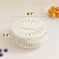 a white strainer with blueberries next to it and measurements for the fruit in front