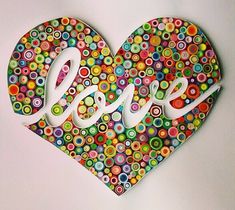 a colorful heart with the word love spelled in white letters on it's side