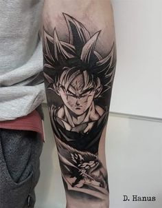 a man's arm with a dragon tattoo on it and an image of gohan