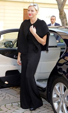 a woman standing in front of a car