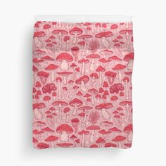 a pink and red bed spread with mushrooms on it