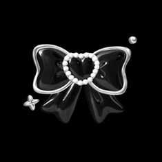 a black and white bow with pearls in the center on a black background, as well as an ornament