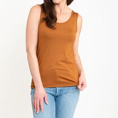 Our versatile two-in-one tank has a scoop neckline on one side and a V-neckline on the other so you can wear it either way. This tank is a basic staple to anyone women's wardrobe. Featuring thick bra-friendly straps, and a smooth, flattering look. Our basic essential tank top is made from lightweight and breathable fabric with smooth soft feeling, providing this cami tank top for women a skin-friendly feel with noticeable softness. This reversible tank top for women can be worn in a multitude of ways from layering or as a summer top with many color options Pairs perfectly with jeans, shorts, or leggings for a casual look, or wear it with a denim jacket, cardigan, or coat to keep warm in colder weather. Care Instructions: Machine wash cold, tumble dry on low. Cool iron if needed. Tank Top For Women, Jacket Cardigan, Soft Feeling, Neck Stretches, Top For Women, Women's Wardrobe, Tank Top Cami, Cami Tanks, Summer Top