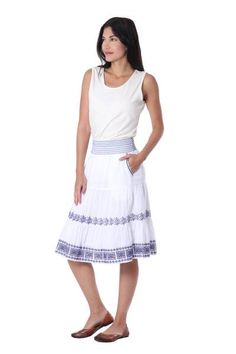 Made of snow white cotton and decorated with intricate lapis embroidery performed in the Moroccan style this skirt is fun and flirty. Indian artisan Sandip Agarwal creates this knee-length skirt featuring handy pockets and an elastic band that hugs the waist. Long Cotton Skirt With Embroidered Hem, Fitted White Skirt With Embroidered Hem, Cotton Tiered Skirt With Embroidered Hem, Knee-length Cotton Ruffled Skirt, Knee-length Floral Embroidered Skirt For Summer, Embroidered Cotton Tiered Skirt, Knee-length Summer Skirt With Floral Embroidery, Summer Knee-length Skirt With Floral Embroidery, White Bohemian Skirt With Embroidered Hem