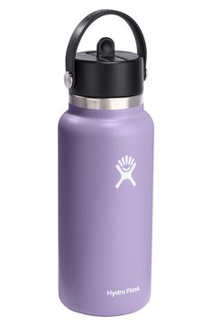 the hydro flask water bottle is purple and has a black lid, with a white logo on it