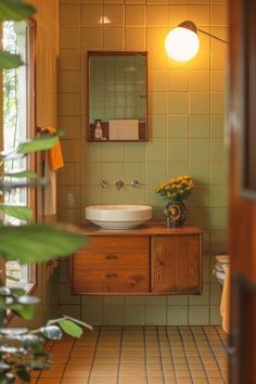 a bathroom with a sink, mirror and plants in the corner on the counter top