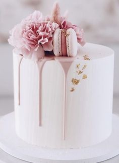 a white cake with pink flowers on top