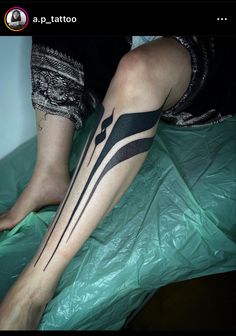 a person with a black and white tattoo on their leg