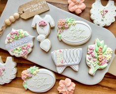 some decorated cookies are on a tray and ready to be cut into pieces for the baby shower