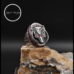 Kurdish bör, a predatory animal with red eyes, is a 925 sterling silver ring with a design of Kurdish bör Turkish is written in Göktürk script on the sides, the ring is engraved with red zircon stones around the ring, names, letters, logos can be engraved on the sides wiping the ring constantly and regularly with a silver polishing cloth, storing it in a dry place in the ring box when not in use, protecting it from moisture, sweat, acid is enough to keep the ring as a memory of you and your futu Silver Wolf Design Ring As Gift, Wolf Design Ring Jewelry Gift, Wolf Design Ring Jewelry For Gift, Silver Ring With Wolf Design, Gothic Silver Ruby Ring Gift, Gift For Husband, Red Eyes, Stylish Jewelry, Ring Box