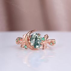 a green ring with leaves and stones on it