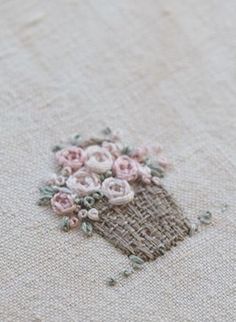 a close up of a piece of cloth with flowers on it and some thread in the middle