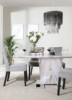 a dining room table with chairs and a chandelier