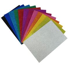 various colors of glitter paper laid out on top of each other