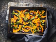 a pan filled with squash covered in pesto