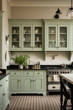 a kitchen with green cabinets and checkered flooring on the floor, along with black counter tops