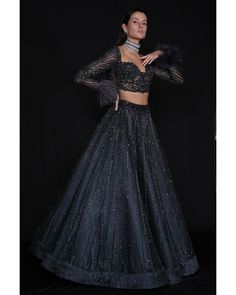 Charcoal Blue Lehenga Set - Bora Honey's Immerse yourself in the allure of our Charcoal Blue Lehenga, a mesmerizing ensemble adorned with an exquisite interplay of stones, crystals, and sequins. The meticulous craftsmanship showcases the intricate detailing of Japanese cut-dana, adding a touch of sophistication and elegance. The ethereal design is further accentuated by delicately incorporated feathers, creating a harmonious blend of tradition and contemporary style in this captivating charcoal Fitted Party Wear Sets For Gala, Fitted Sets For Gala Party Wear, Embellished Fitted Sets For Gala, Fitted Black Set For Gala, Fitted Black Sets For Gala, Black Fitted Sets For Gala, Embellished Fitted Lehenga For Gala, Glamorous Blue Sets For Reception, Blue Party Wear Sets For Evening