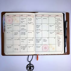 an open planner with a key hanging from it